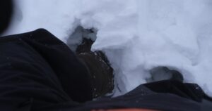 a person is laying down in the snow